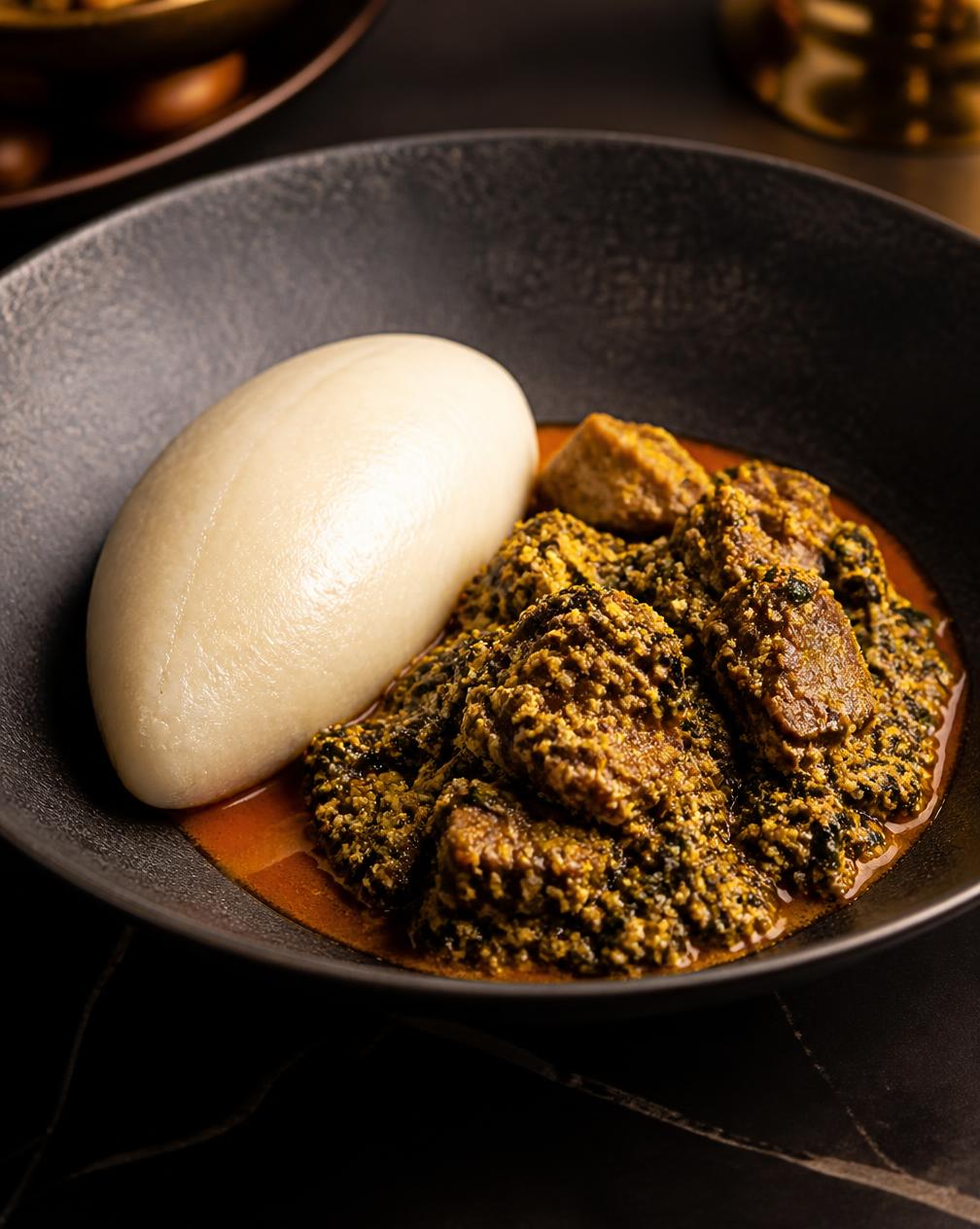 Pounded Yam & Egusi — Silken pounded yam with a rich melon-seed egusi, bitter leaf and slow-braised beef.