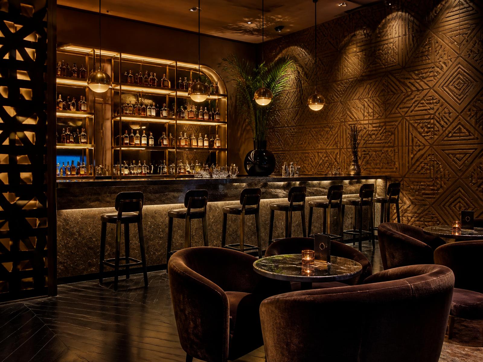 The Lounge at Lumière — Velvet, brass and a long marble bar — for the drink before, or the one after.